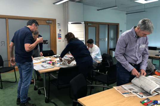 Delegates scanning the daily newspapers and industry magazines for trends, opportunities and market developments